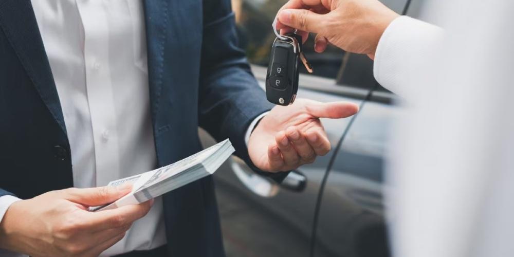  Two individuals conducting a transaction with one handing over a stack of cash and the other offering car keys.